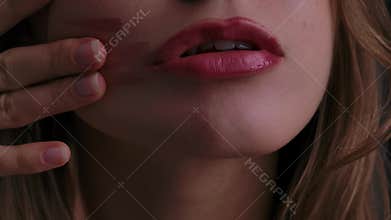 Close up of Woman Lips with Lipstick Smudge and Fingers