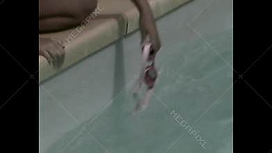 Vintage girl crouching on poolside during sunny day