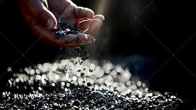 Medium shot of a worker inspecting certified sustainable tungsten ore in a clean ecofriendly mining facility promoting