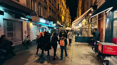 LYON, FRANCE - NOVEMBER 24, 2025. Busy pedestrian street with restaurants and evening crowds