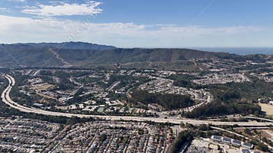 Aerial view of residential suburbs and green hills in San Francisco Bay Area Peninsula