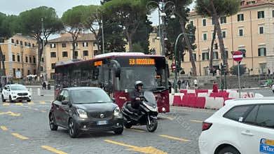 Rome, Italy 12.16.2025 Traffic near the Colosseum in Rome Italy with buses on routes 51 and 13 bas motorcycles taxis and