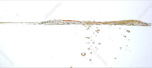 Slow-motion cherry tomatoes drop and splash into clear water