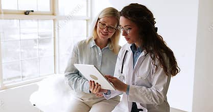 Doctor in coat explains diagnosis or treatment options to patient