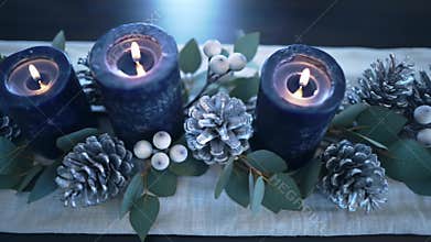 Cinematic Close Up of Elegant Blue Advent Candles and Winter Centerpiece