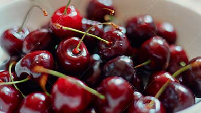 glass plate with ripe cherries close-up