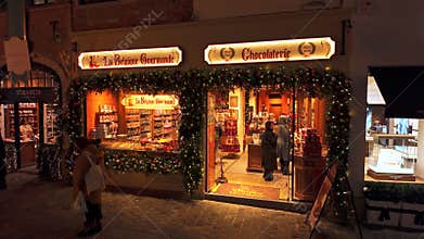 BRUSSELS, BELGIUM - NOVEMBER 26, 2025 - La Belgique Gourmande chocolaterie in Brussels at Christmas night