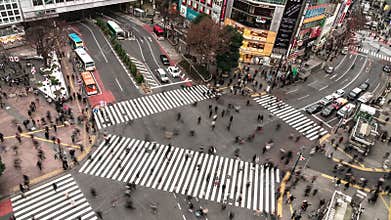 4K UHD Aerial view time-lapse of Shibuya zebra crossing with crowded people and car traffic transport across intersection