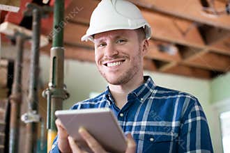 Portrait Of Architect Inside House Being Renovated Using Digital Tablet