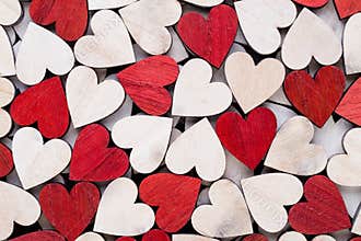 Valentines day background with white end red hearts on wooden background
