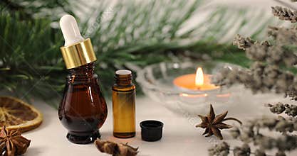 Aromatherapy treatment - essential oil bottles with herbs and candle