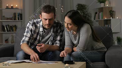 Couple accounting checking receipts at home