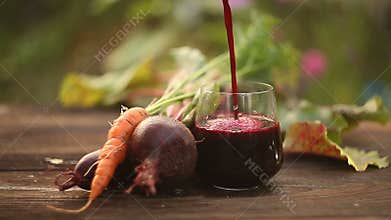 Beet-Carrot juice in glass on table