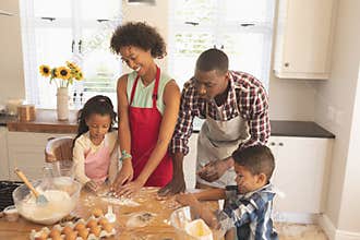 African American family baking cookies in kitchen