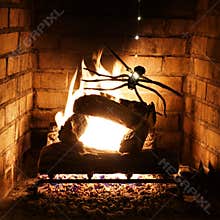 Fake toy spider descends by tealight spinnaret roaring fire