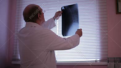 Doctor analyzing x-ray.