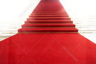 Staircase with red carpet, illuminated by light