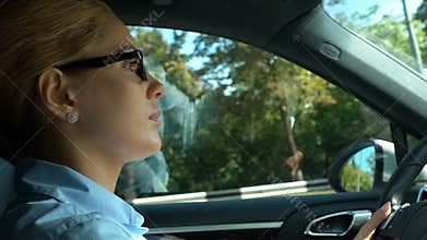 Attentive business lady driving automobile, traffic rules and safety on roads