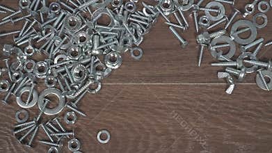 Type of bolts nuts screws on the table close-up hand