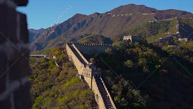 A section of the Chinese Great wall that rises up the side of the mountain in a begining of fall