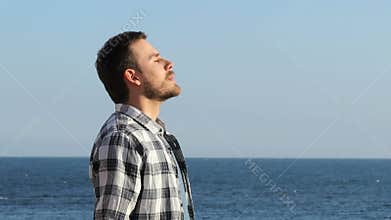 Man relaxing breathing fresh air on the beach