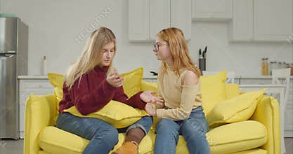 Sympathetic girl consoling friend after breakup