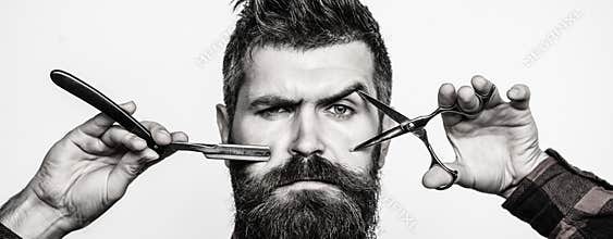 Bearded man, bearded male. Portrait of stylish man beard. Barber scissors and straight razor, barber shop. Vintage