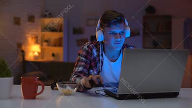 Overemotional teen boy losing video game, inadequate emotional reaction, addict