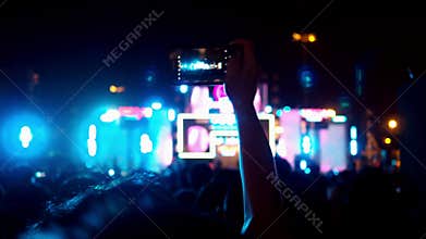 Hands of audience crowd people taking photo with mobile smart phone concert on music festival