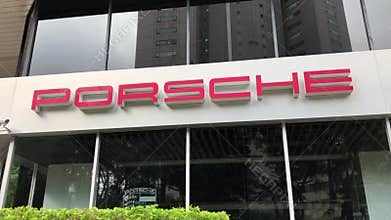 Porsche automobile dealership sign on building