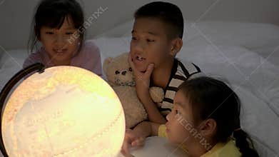 Children`s grop learning about geography at bedroom.