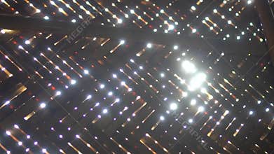 Sun rays shining through bamboo wall of bungalow