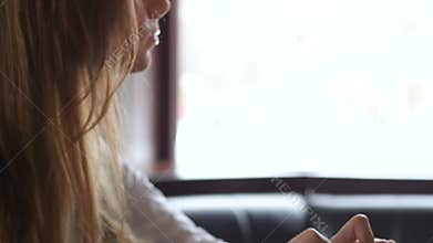 Pensive female writer working on laptop, beginning new roman chapter, bestseller
