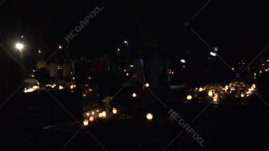 Priests and christian fold people chant canticle at night graveyard. Follow. 4K