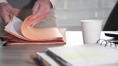 Businessman searching for a document in folders