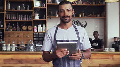 Happy cafe owner using digital tablet
