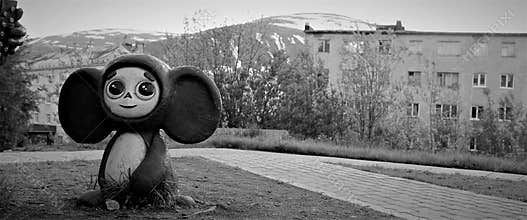 Cheburashka on the background of mountains