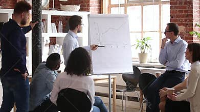 Confident speaker coach gives corporate presentation on whiteboard at meeting
