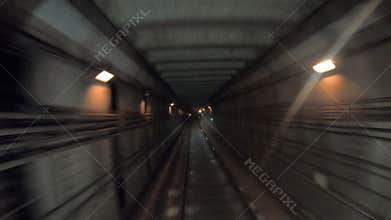 Fast speed underground train riding in a tunnel of the modern city. Point of view from the railway cabin. Time lapse of