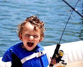 Toddler Boy fishing on a boat