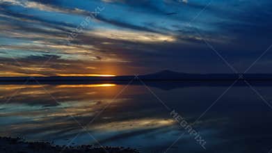 Sunset falling over Atacama salar and Chaxa lagoon reflection