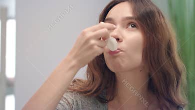 Happy woman drinking liquid syrup for healing cough in bath room