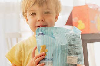 Cute child with pack of chips