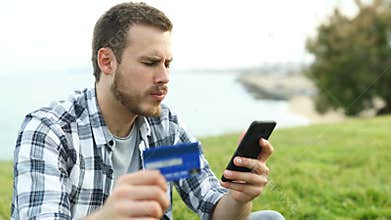 Boy paying with credit card and phone makes mistake