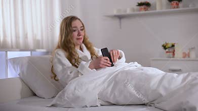 Young woman typing message to boyfriend with hatred, disappointed in love