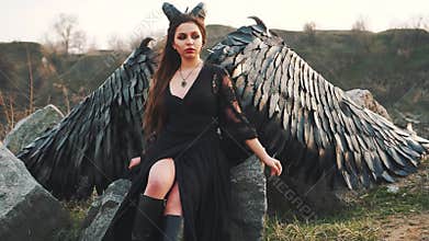 Black queen of darkness waiting for awesome army, raven girl with big strong wings and horns, lady listens to wind