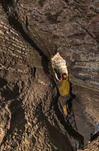 Speleologist in front of difficult place in cave