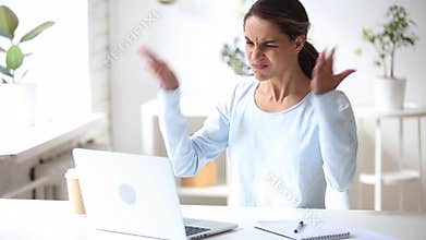 Angry stressed young businesswoman feeling mad using stuck computer