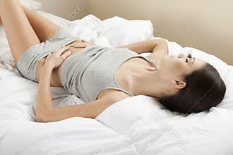 Young woman stroking her belly
