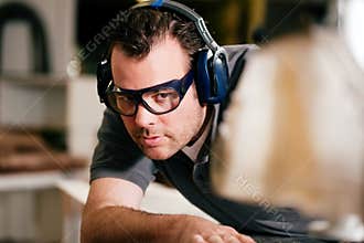 Carpenter using electric saw